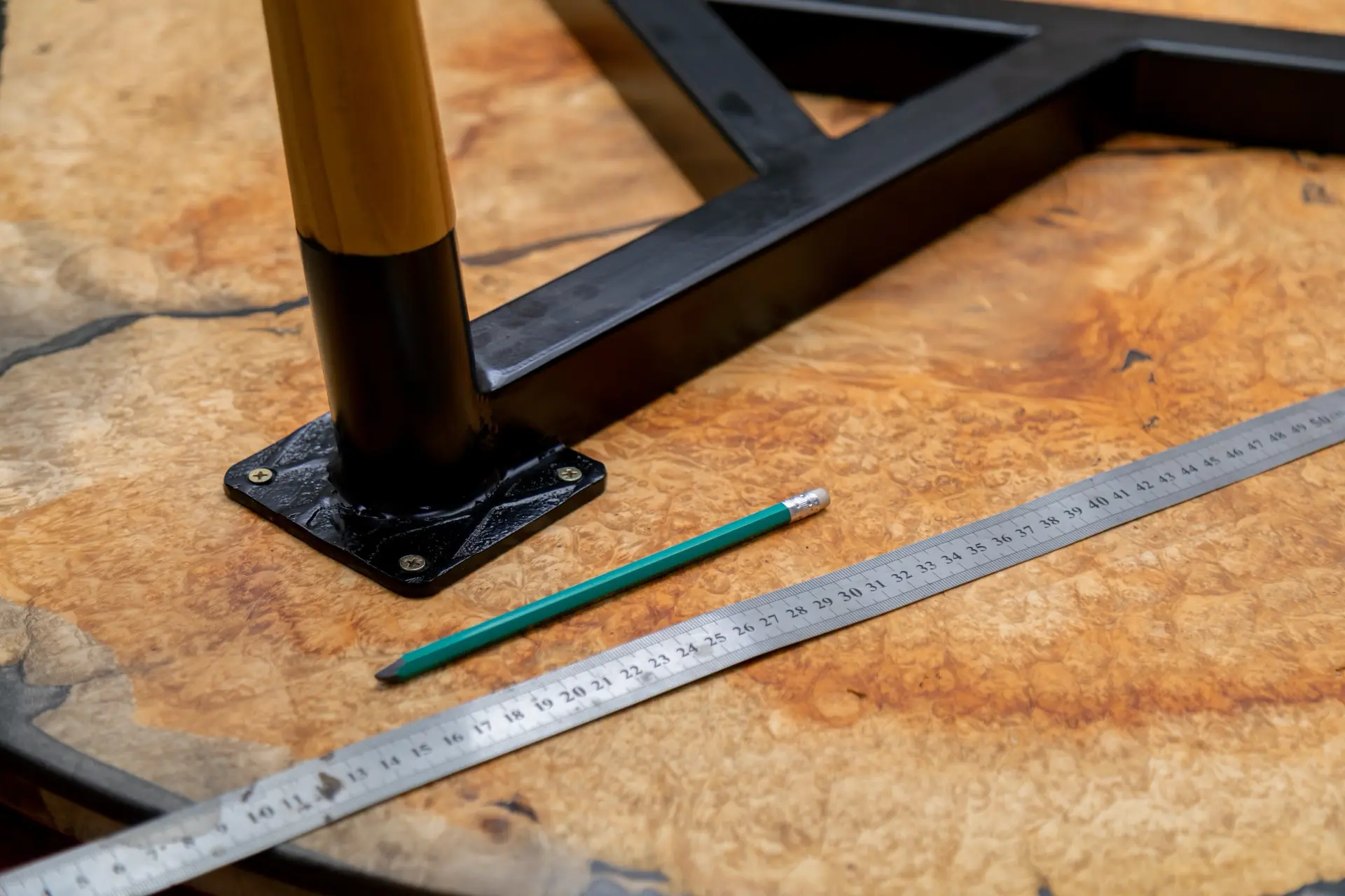 closeup-of-iron-ruler-with-pen-on-a-wood-table-2025-03-31-11-28-23-utc closeup of iron ruler with pen on a wood table 2025 03 31 11 28 23 utc